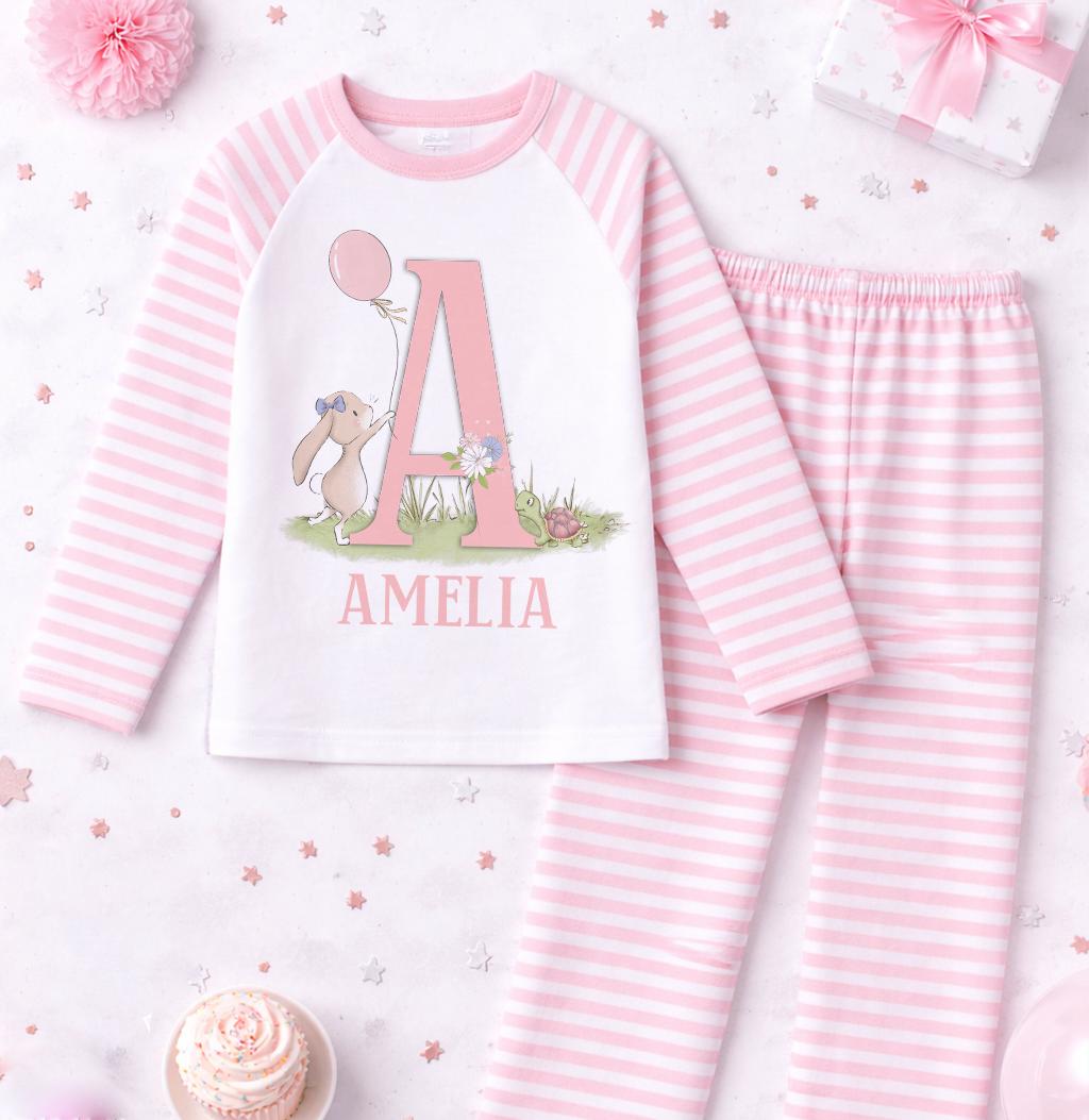 Close-up of the bunny motif and personalised name printed on the pink stripe pyjama top