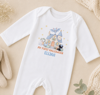 A white onesie with a Halloween-themed design, including a house, bats, and a teddy bear, along with the text "My first Halloween Elijah".