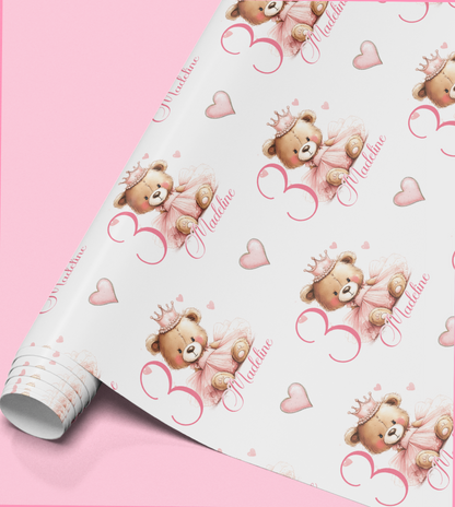 Personalised pink teddy bear wrapping paper design shown with a sample name