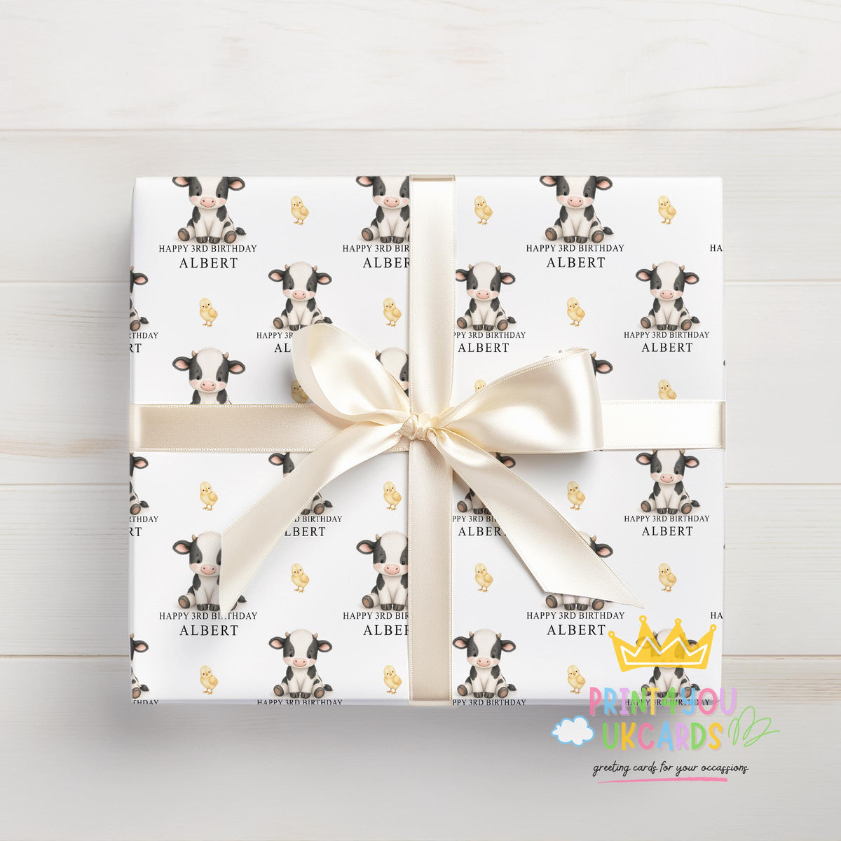 Section of the personalised cow wrapping paper showing the cow print and personalisation