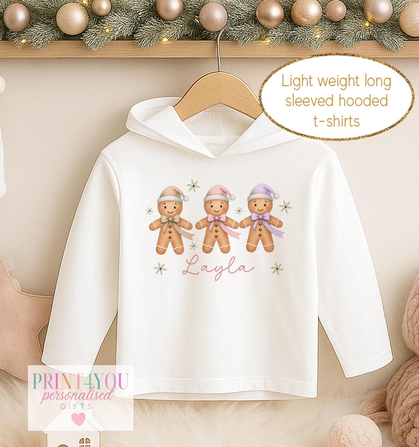 Personalised Christmas hooded t-shirt for girls, white long sleeved hoodie printed with three gingerbread men in pink bobble hats and a name