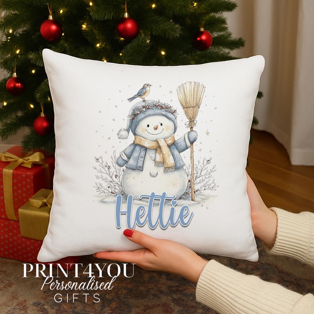 Personalised Christmas cushion with a watercolour snowman in a blue hat and scarf and a robin on top, custom name printed on the front, cushion cover only