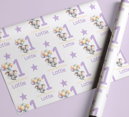 Personalised purple elephant birthday wrapping paper wrapped around a gift box, ready to give.