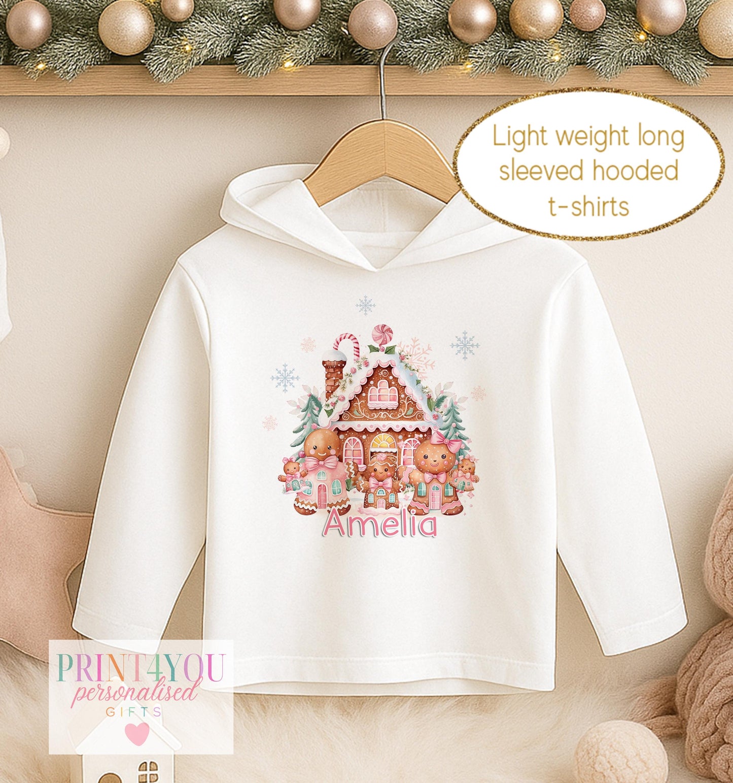 Personalised Christmas hooded t-shirt for girls, white long sleeved hoodie printed with a decorated gingerbread house and a name