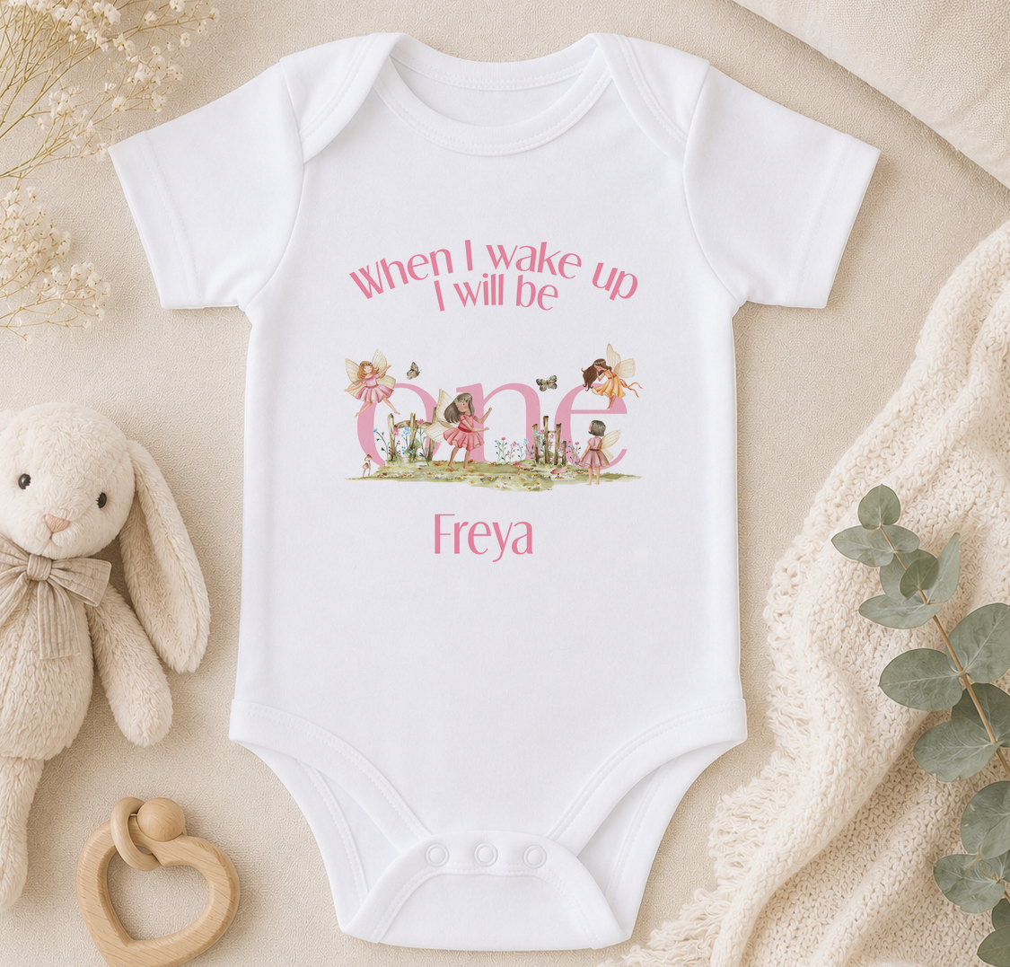 Personalised fairy onesie styled on a bed with a soft toy and greenery