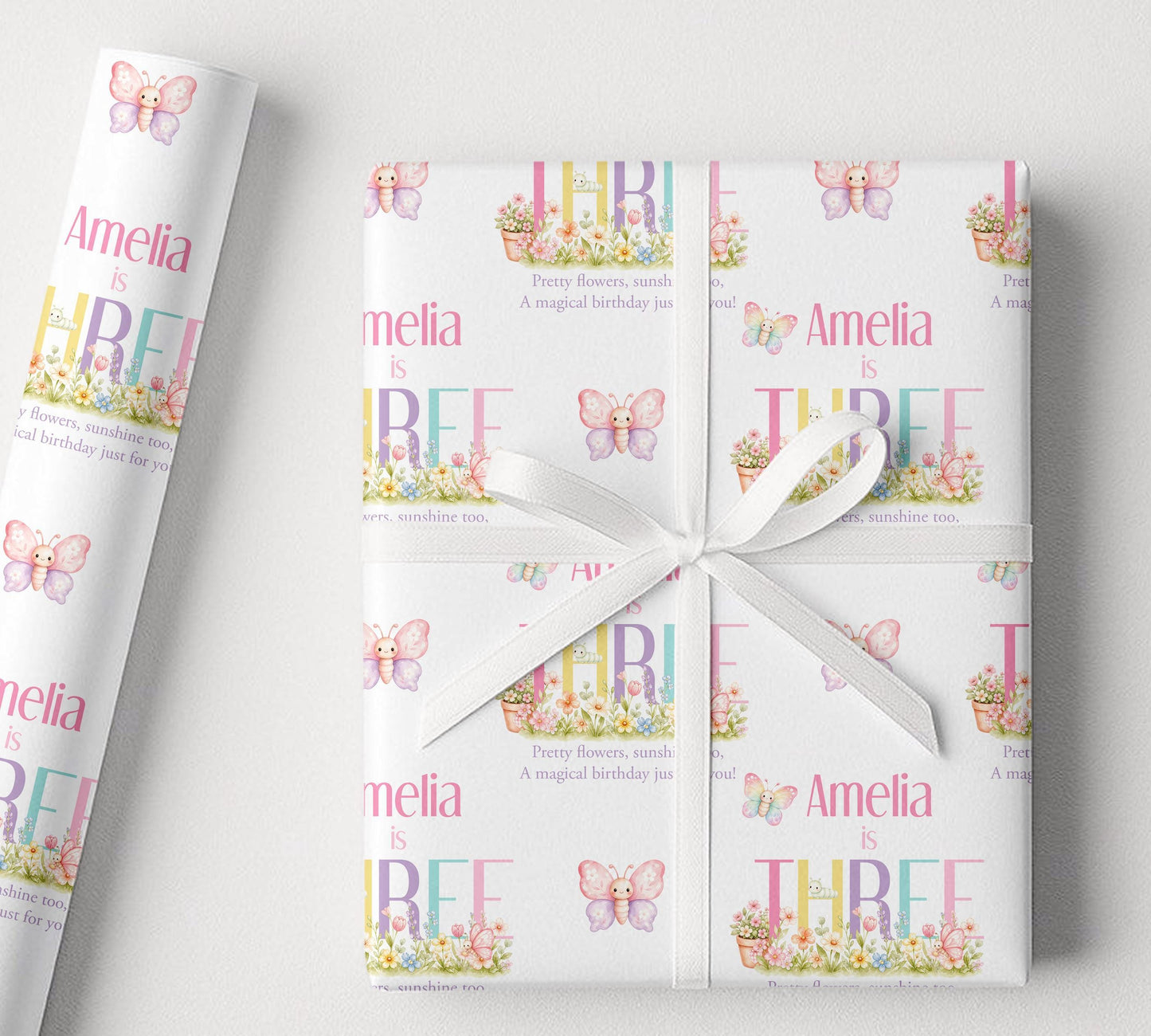 Sheet of personalised butterfly garden birthday wrapping paper laid flat