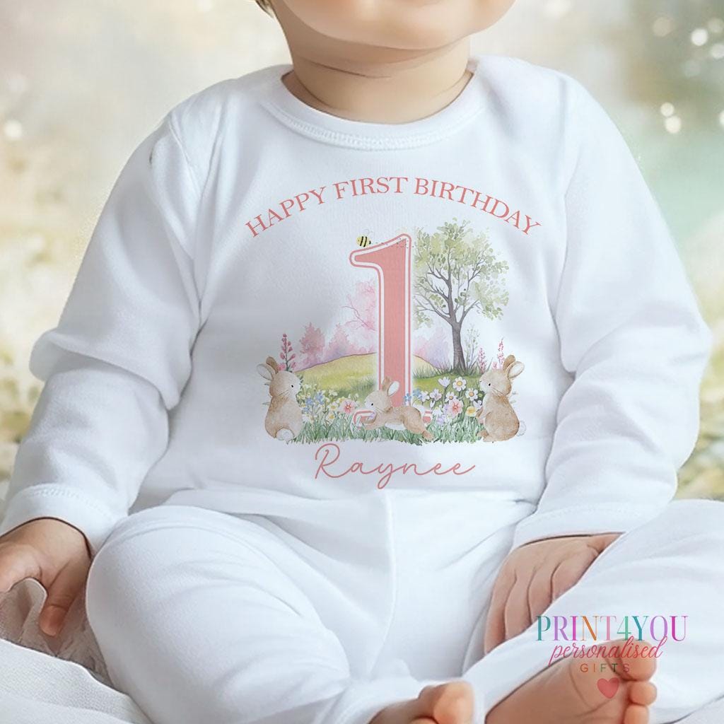 Personalised bunny rabbit first birthday bib with hook-and-loop fastening and printed name.