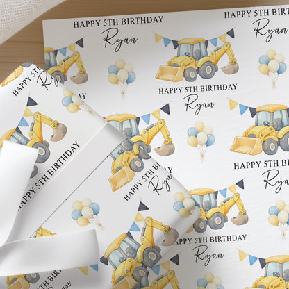 Repeating pattern of yellow diggers and construction vehicles on personalised birthday wrapping paper