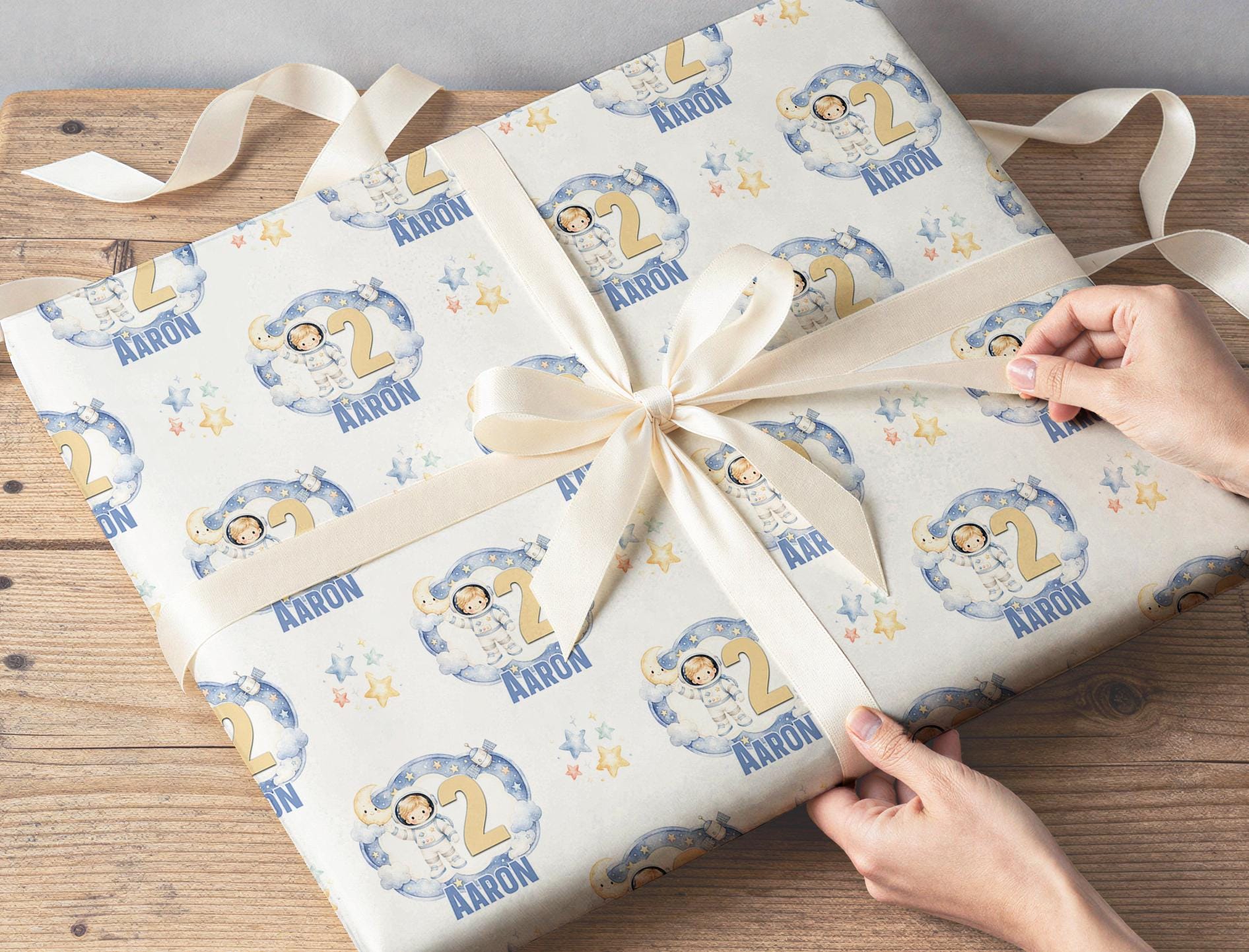 Section of the personalised galaxy wrapping paper showing stars, planets and personalisation