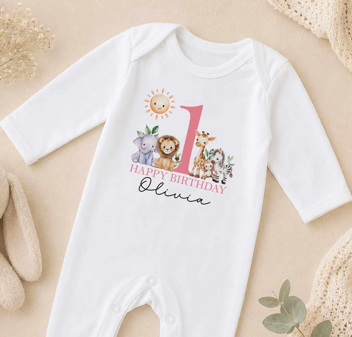 Personalised white baby vest printed with a sun, giraffe, lion and elephant and 'Happy Birthday Olivia'.