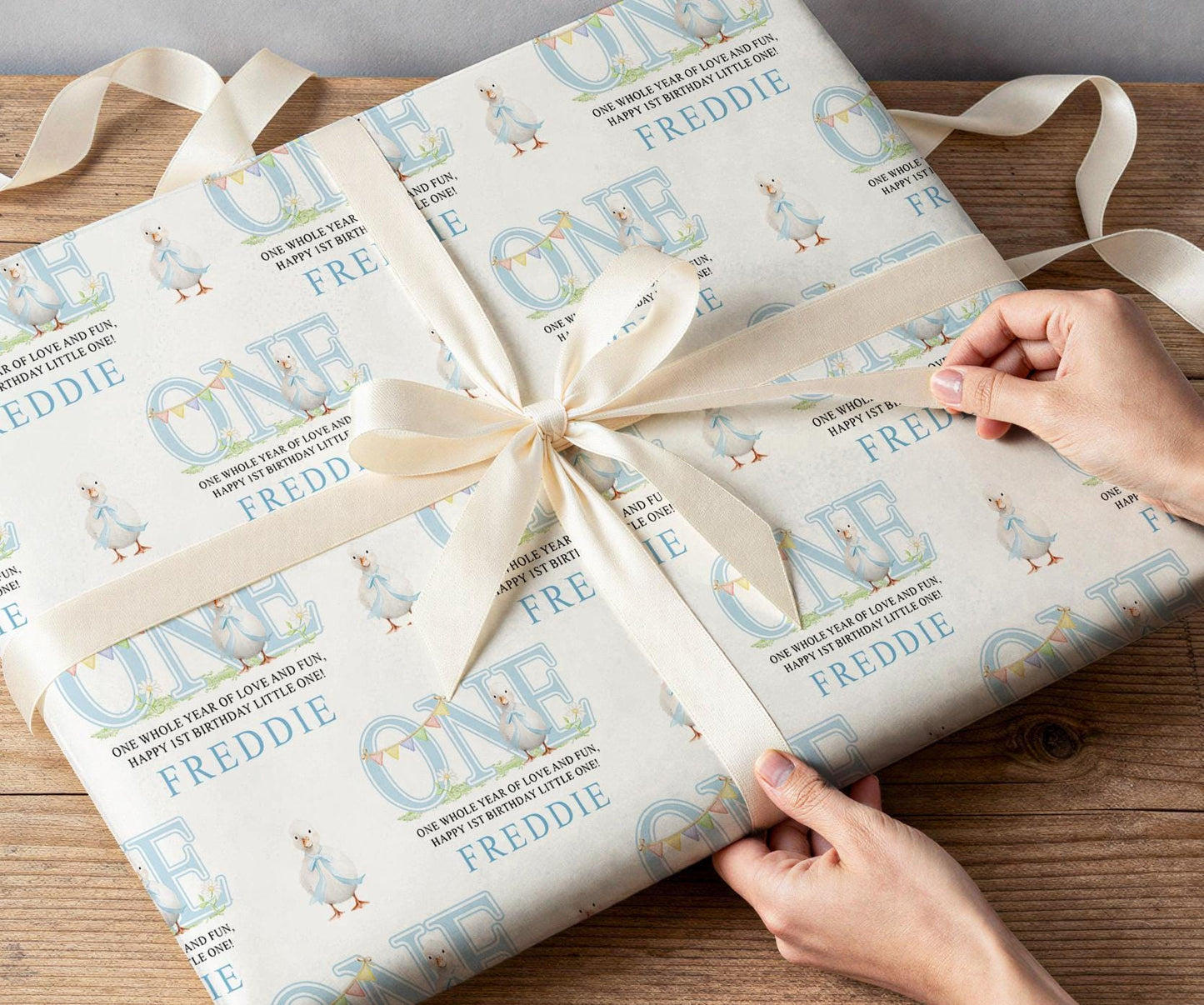 Detail of the blue duck wrapping paper design showing the duck illustrations and personalised name.