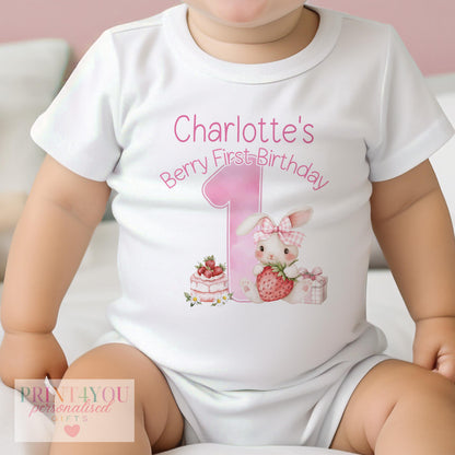 Personalised strawberry bunny first birthday outfit with a bold number one and baby's name printed on soft cotton.