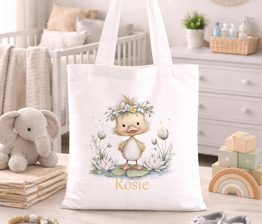 Small cotton tote bag printed with a cheerful yellow duck illustration and space for a personalised child's name