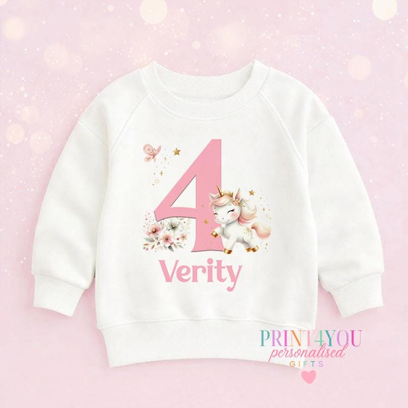 White cotton children's sweatshirt personalised with a unicorn design, a child's name and birthday number.