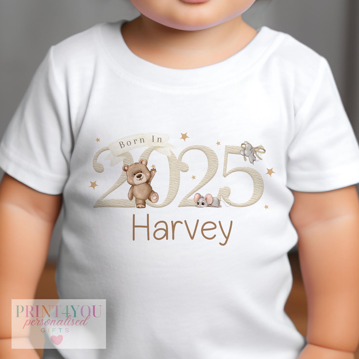Close-up of the teddy bear and mouse print on the personalised newborn vest.