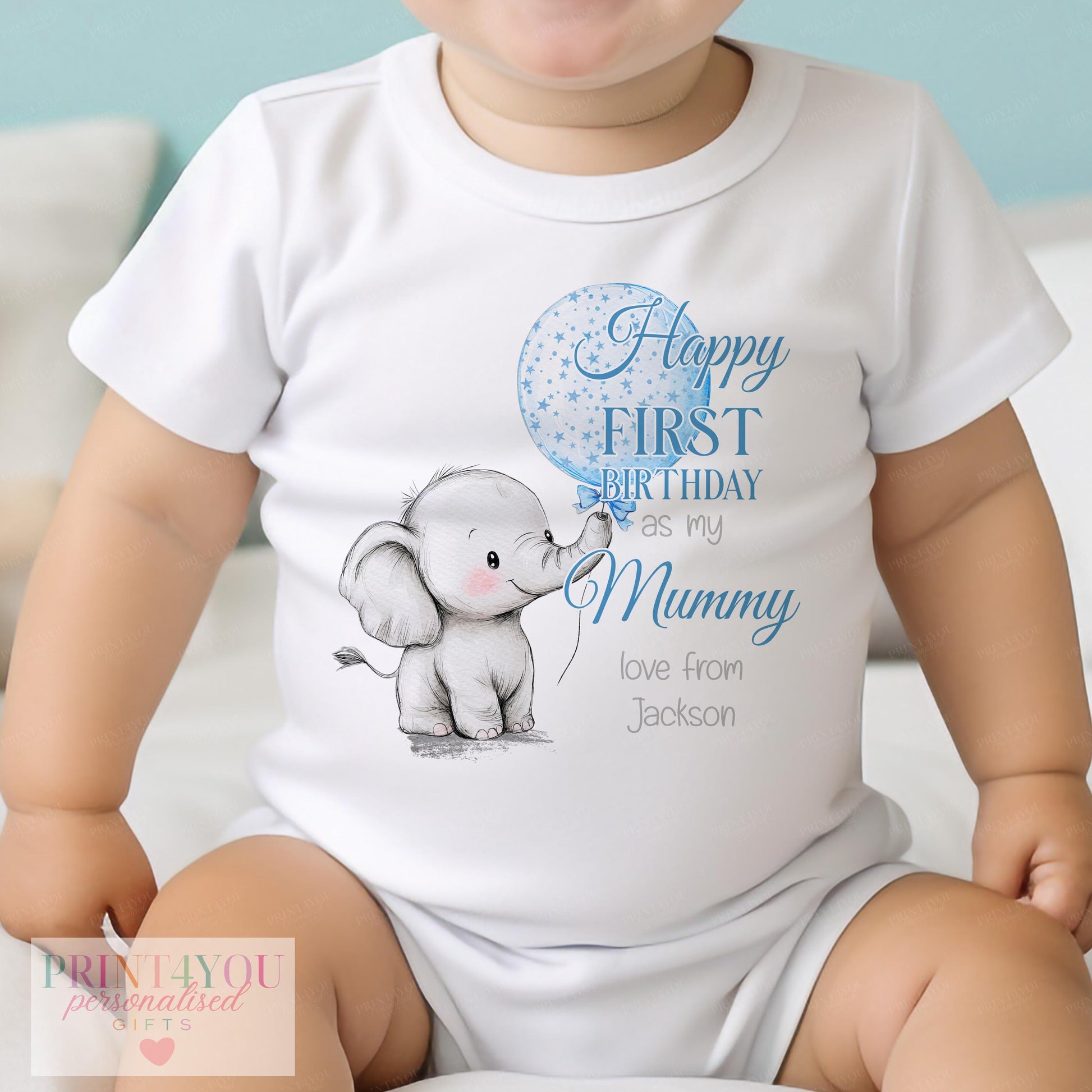 Close-up of the starry elephant and balloon print with personalised name on baby clothing