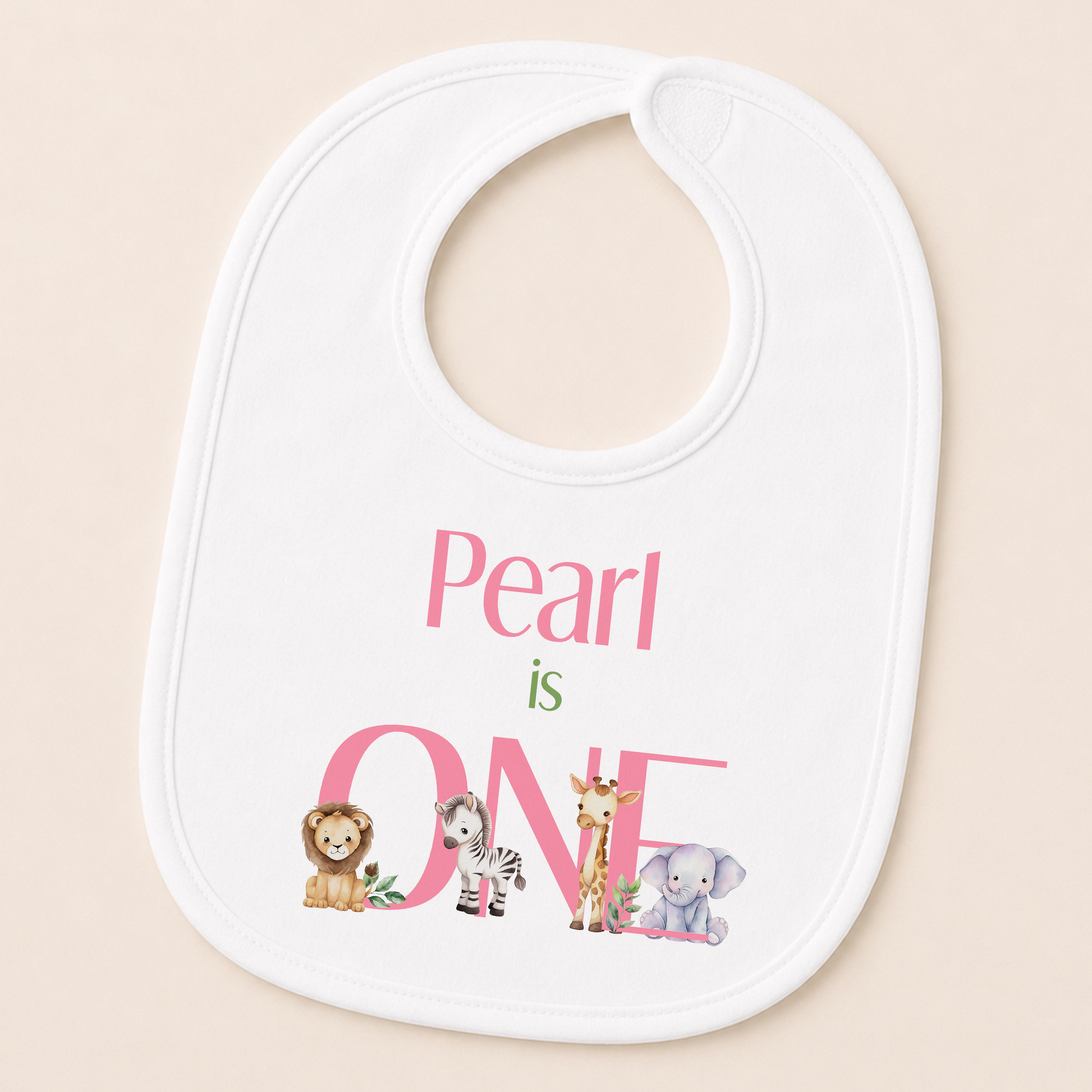 Personalised safari first birthday bib with pink text and safari animal print.