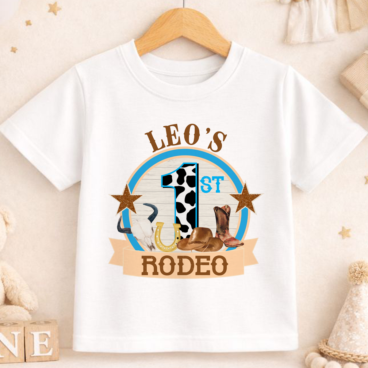 Personalised cowboy rodeo first birthday t-shirt with cow print number one and custom name.