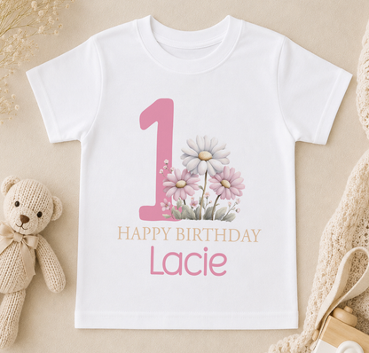 Personalised white t-shirt printed with a pink number one, floral design and 'Happy Birthday' name print for a first birthday
