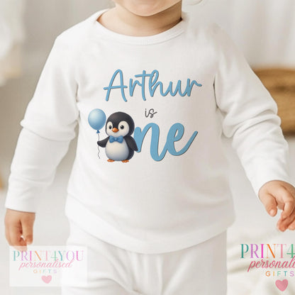 Personalised blue penguin first birthday sleepsuit with custom name printed on soft cotton