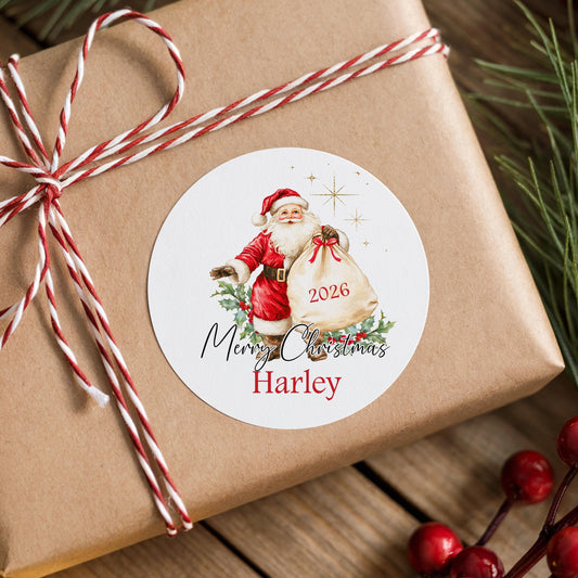 A brown gift box wrapped with red and white twine, featuring a round sticker with a Santa Claus illustration and the text "Merry Christmas Harley" on it.