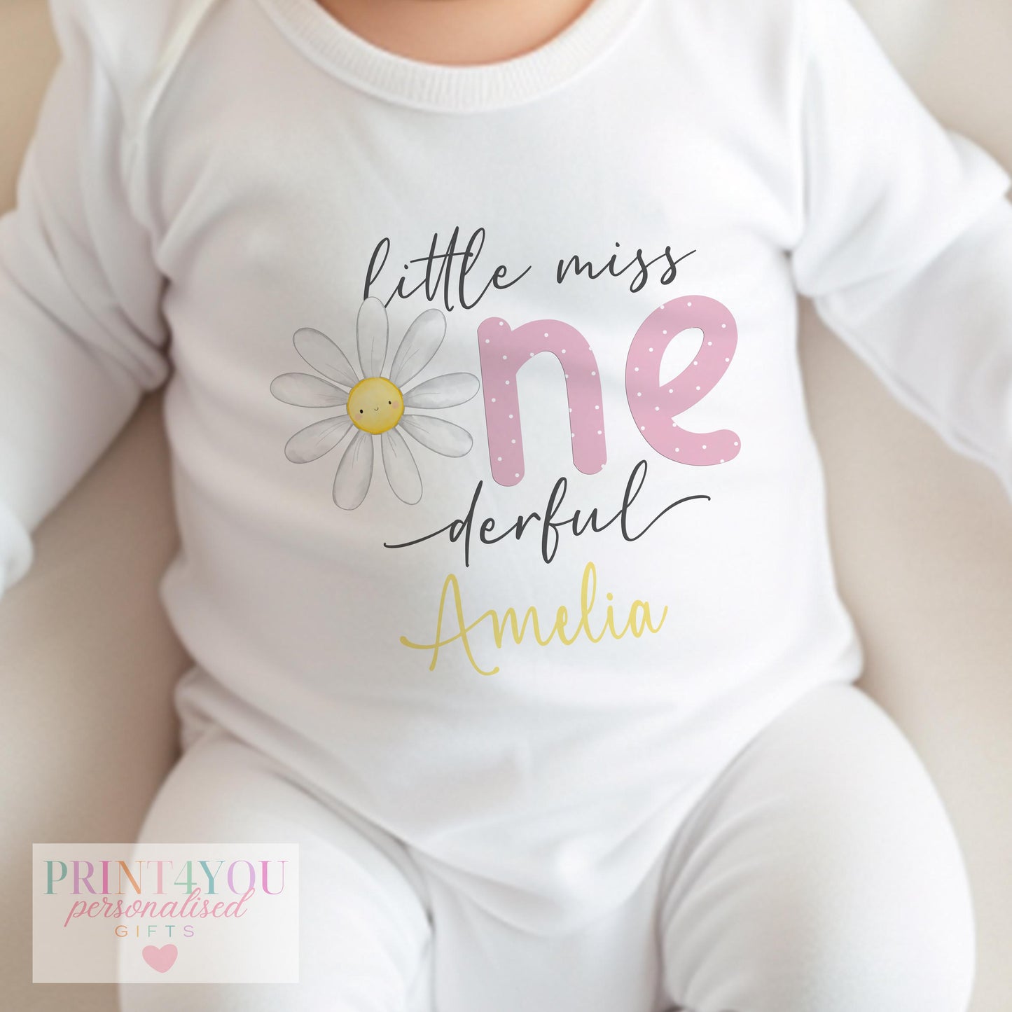 Close-up of the Little Miss One-derful daisy design with the personalised name in golden yellow.