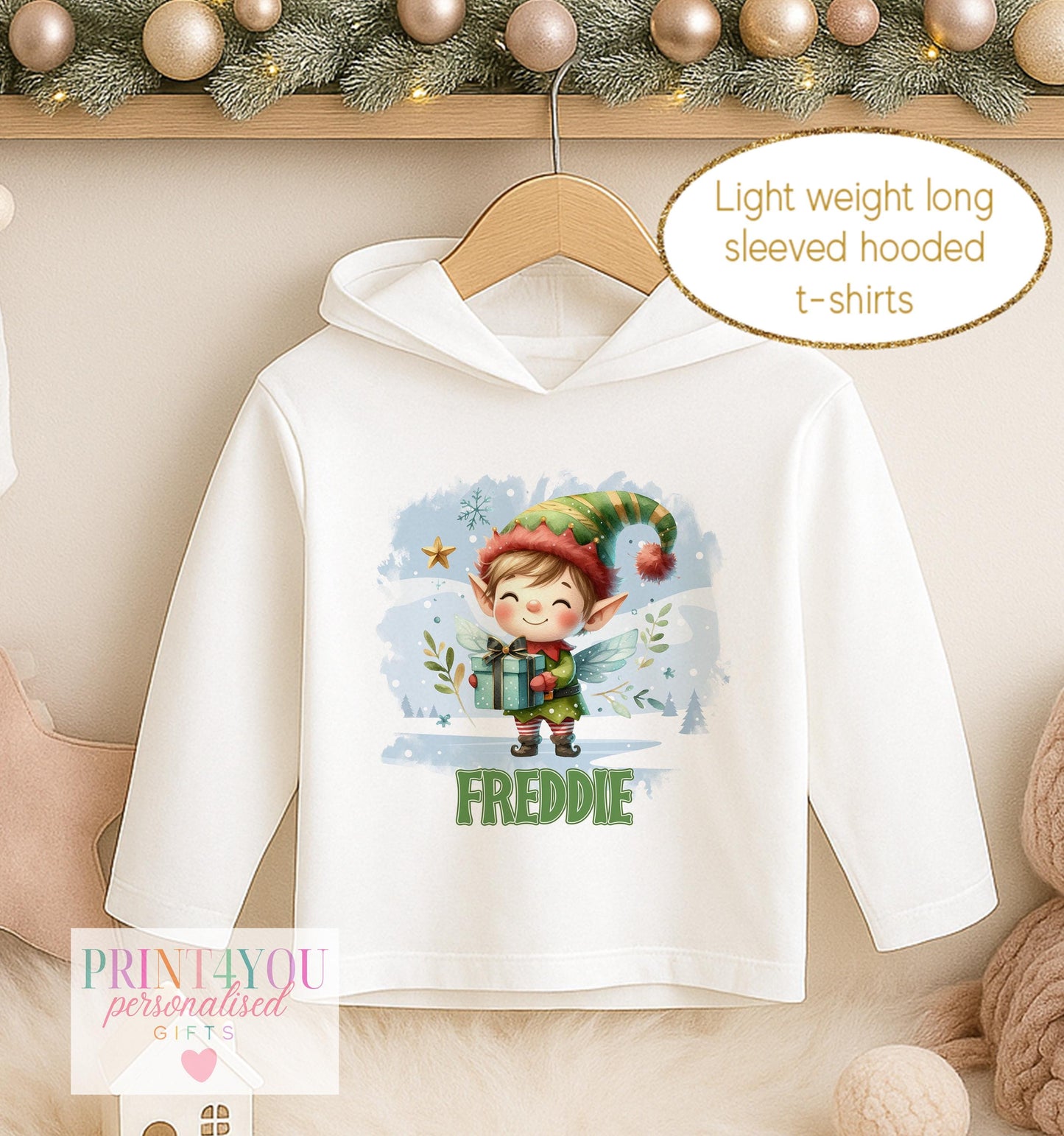 Personalised Christmas hooded t-shirt, white long sleeved hoodie printed with a cheerful elf in a snowy pine scene and a name