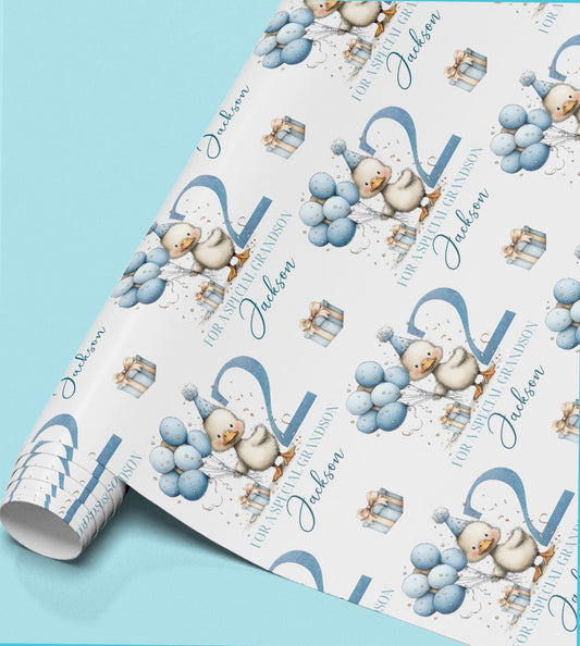 Roll of personalised blue duck birthday wrapping paper printed with the name Jackson, featuring a duck wearing a party hat and holding balloons.