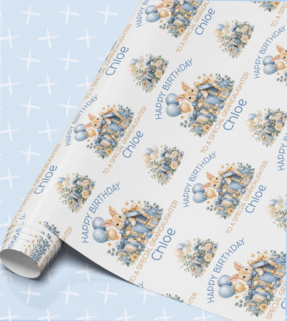 Personalised birthday wrapping paper in blue with bunny rabbits, balloons and flowers, Happy Birthday with a relation and name