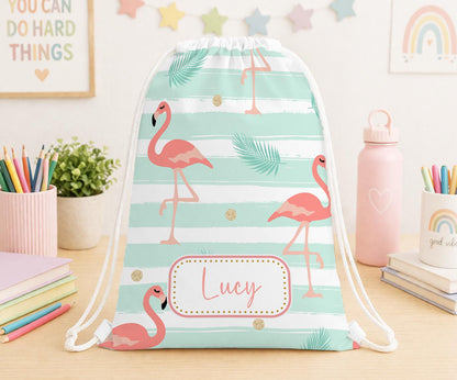 Personalised white drawstring PE bag printed with a bright pink tropical flamingo design and the child's name