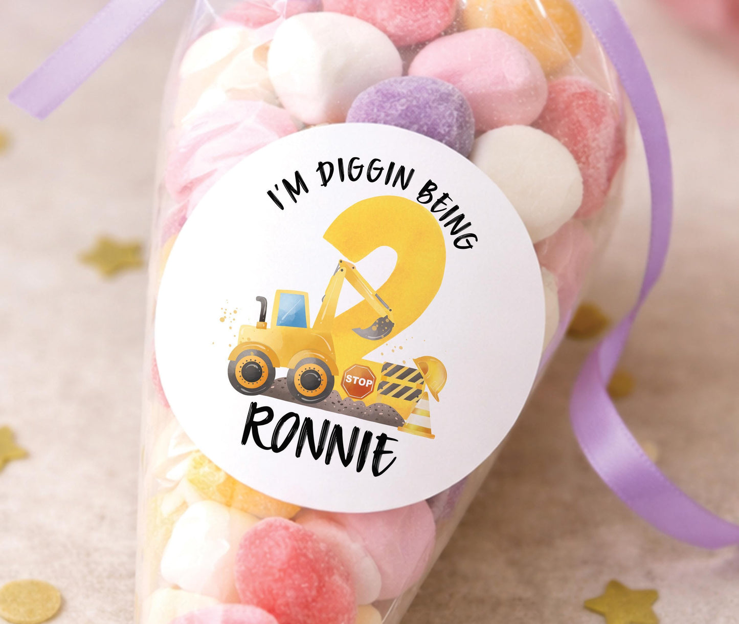 Sheet of glossy round stickers featuring a construction site and digger birthday design, personalised with a child's name