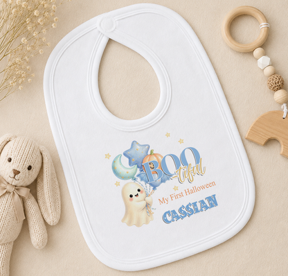 A white baby bib with a Halloween-themed design, featuring a ghost, pumpkin, and stars, along with the text "My first Halloween Cassian".