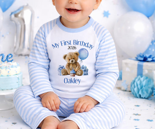 Personalised first birthday outfit with a blue teddy bear design and the baby's name printed on the front.