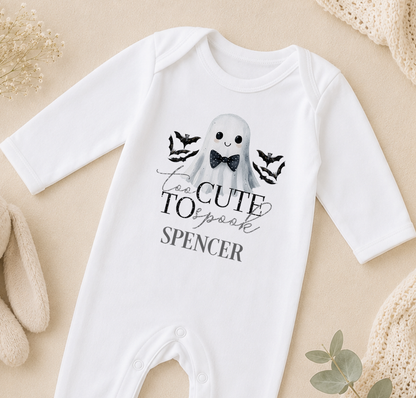 A white onesie with a graphic of a ghost and the text "Too Cute to scare" printed on it.