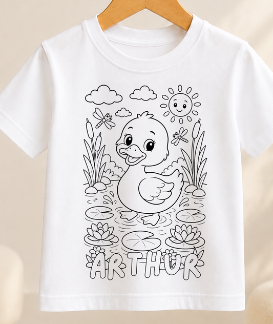 Colour-in kids t-shirt with a black-and-white line art duck paddling on a pond, personalised with a name