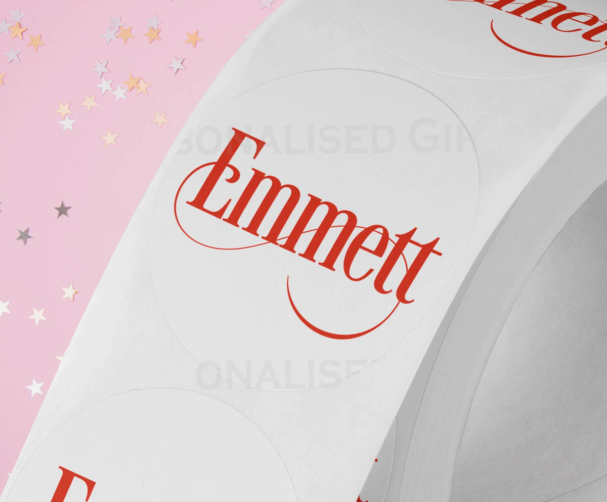 Personalised coloured festive name Christmas gift label sticker styled on a wrapped present, custom name printed