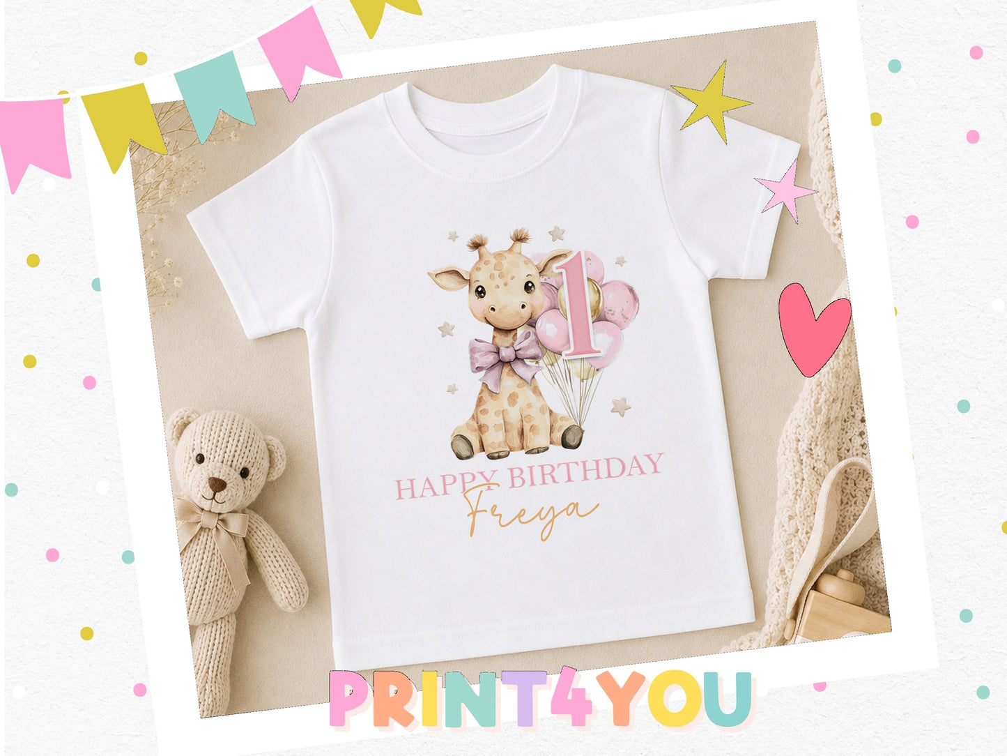 Personalised giraffe birthday t-shirt with balloons, styled with a teddy bear and party decorations.