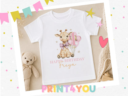 Personalised giraffe birthday t-shirt with balloons, styled with a teddy bear and party decorations.