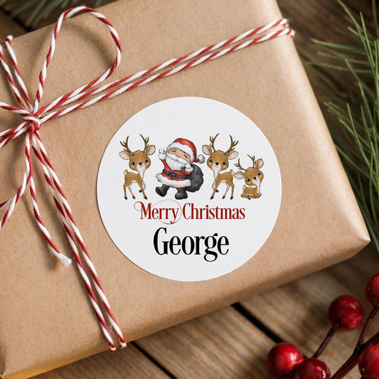 A brown gift box with a red and white striped ribbon tied around it, featuring a round sticker with a Santa Claus illustration and the text "Merry Christmas George".
