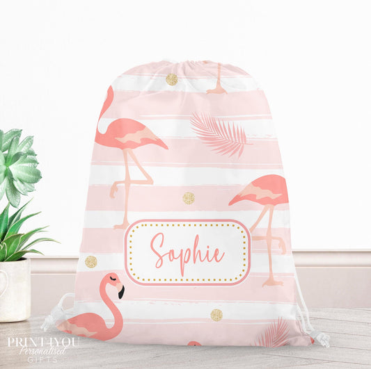 Pink drawstring PE bag printed with a flamingo, palm leaf and gold dot design, personalised with a child's name across the front