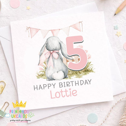 Square personalised birthday card featuring a bunny illustration and pastel bunting, with space for a child's name and age