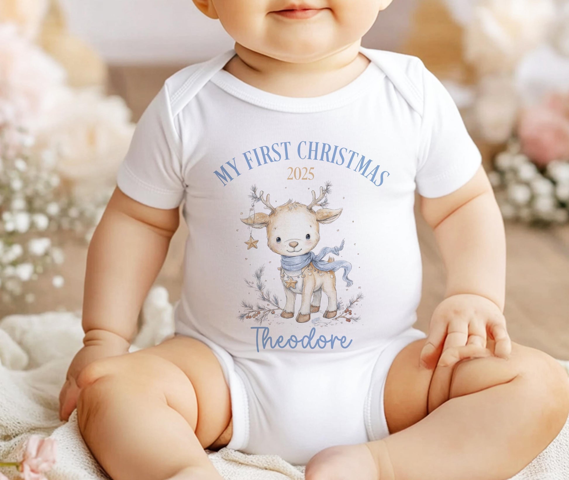 Personalised Christmas baby sleepsuit with reindeer design and custom name.
