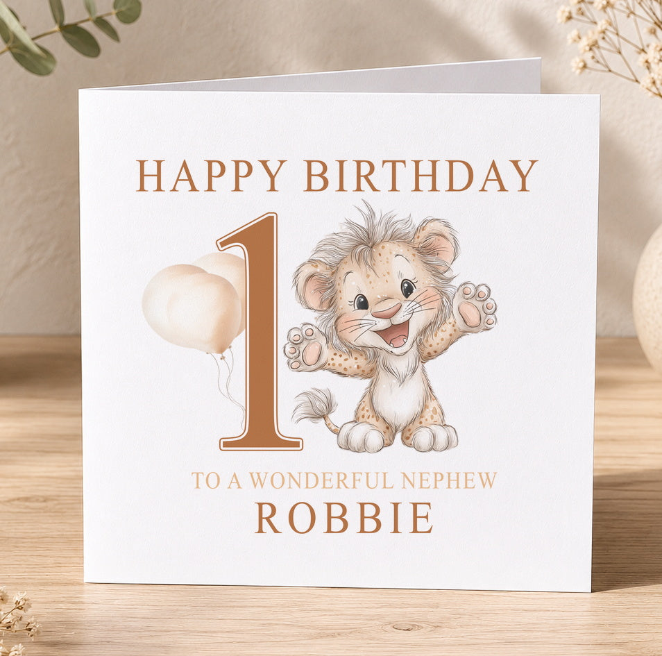 First birthday card featuring an illustrated baby lion, printed with 'Happy Birthday 1 to a wonderful nephew Robbie' as a personalisation example.