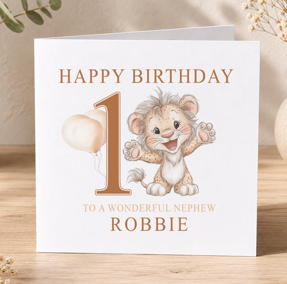 First birthday card featuring an illustrated baby lion, printed with 'Happy Birthday 1 to a wonderful nephew Robbie' as a personalisation example.