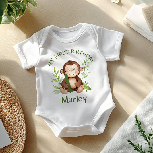 Personalised safari monkey first birthday bib, printed with your baby's name in bold green lettering.