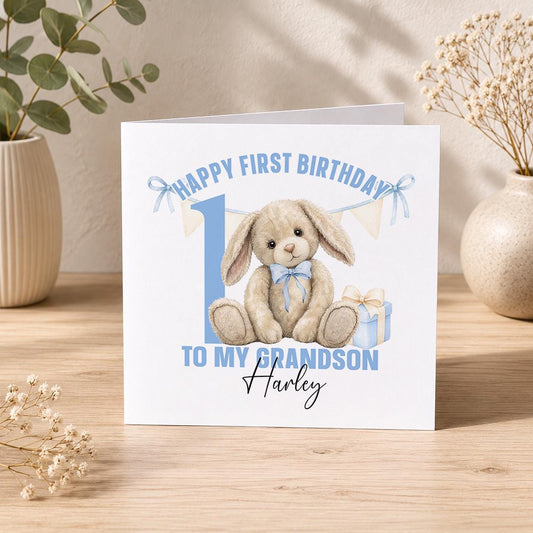 Square personalised first birthday greeting card with a blue floppy-eared bunny design for a baby boy