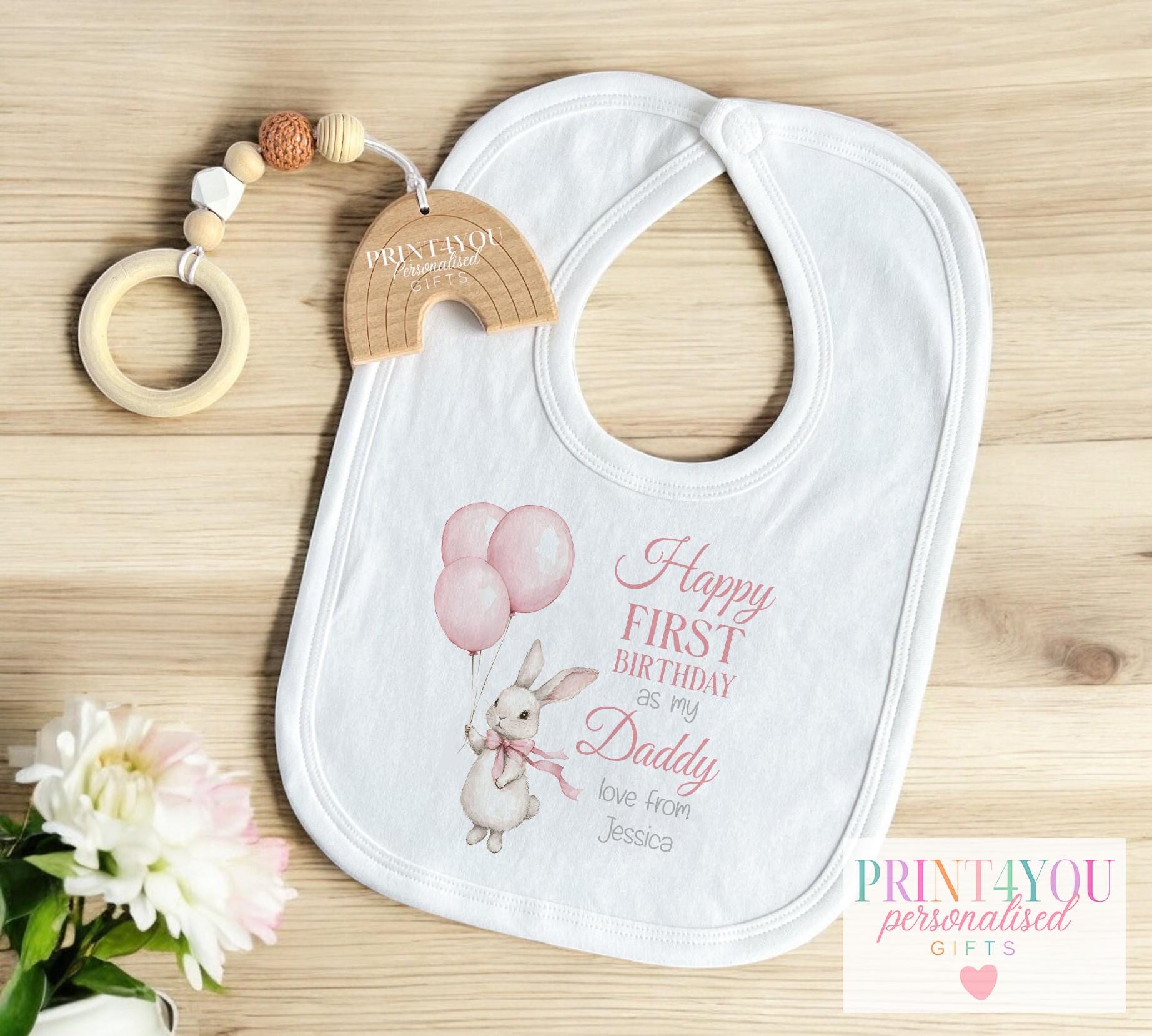 Personalised pink bunny first birthday t-shirt, printed with the baby's name and chosen family title.