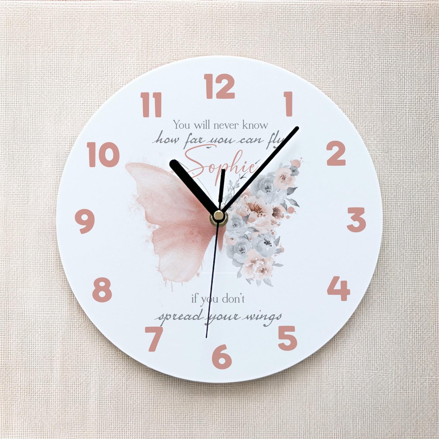 Personalised blush butterfly acrylic clock displayed on a girl's bedroom wall