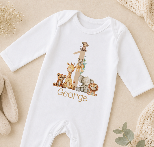 A white onesie with a personalized number 1 and animal print design, along with the name "George" printed on it.