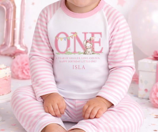 Personalised first birthday pyjamas with pink bunny design and custom name, soft cotton